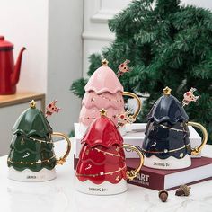 three star wars themed coffee mugs sitting on top of a table next to a christmas tree