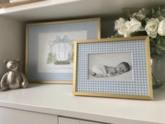 two baby pictures are sitting on a shelf next to a vase with flowers and a teddy bear