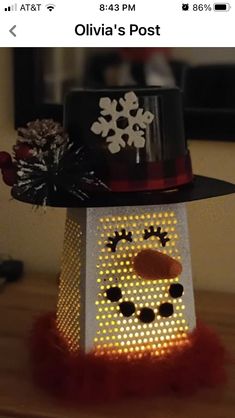 a light up snowman wearing a black hat