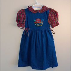 Girls Size 6x Vintage Deadstock New With Tags Denim Dress With Plaid Puff Sleeves, Plaid Ruffle Collar, And 2 Plaid Bow Ties On Each Side. The Front Of The Dress Has An Embroidered Basket Of Plaid Apples. This Dress Is 100% Cotton. R 1 Blue Cotton Denim Playtime Dress, Blue Cotton Denim Dress For Playtime, Cute Short Sleeve Denim Dress, Playful Denim Dress For Playtime, Cute Denim Dress For Playtime, Casual Dresses For Playtime In Fall, Blue Denim Dress For Playdate, Blue Fall Playtime Dress, Blue Dress For Playtime In Fall