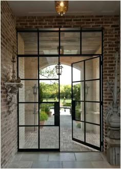 an open glass door leading into a garden