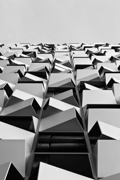 black and white photograph of an abstract building with lots of cubes on the side