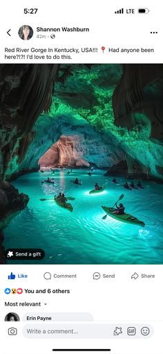 two people kayaking in a cave with blue water and green lights on the ceiling