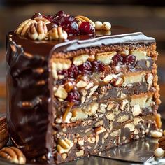 a piece of chocolate cake with nuts and cranberry toppings on a plate