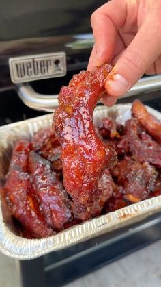 a person is dipping some food into a pan