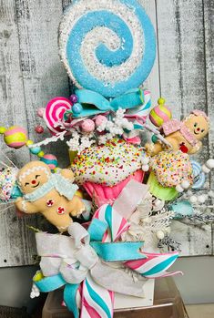 a bunch of stuffed animals sitting on top of a pile of cake and candies