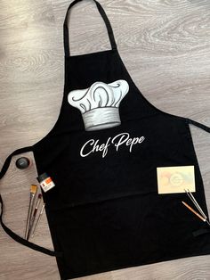 Handpainted Cooking Apron, Personalized Chef Apron, Custom Name Apron, Kitchen Apron, Baking Gift, Housewarming Gift, Master Chef Apron 100% Cotton 100% Love ❤ Hand Painted Cooking Apron by JulieBoutiqueAndArt! Unique Kitchen Apron - hand painted with professional water resistant textile paint for cooking lovers. If you want to make your loved one or yourself happy  with a gift personalized with his name. Just type the name or other caption in the personalization option. The apron can be made in Textile Paint, Baking Gift, Handmade Aprons, Apron Kitchen, Baking Gifts, Gift Housewarming, Master Chef, Chef Apron, Kitchen Apron