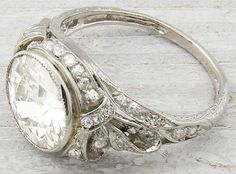 an antique diamond ring on a wooden surface