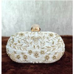 This stunning Party Clutch Bag is embellished with Zardozi work on a white silk Base . This Minaudière Clutch is ideal for parties and weddings and any festive occasion. This Handmade Embroidered Embellished Sling Purse can be used with or without the metal sling that is included. Dazzle through the Day or Evening with this beautifully Handcrafted Wedding Bridal Clutch Bag. Perfect for a Bride, Bridal Gift, Bridal Clutch, Wedding Clutch, Mehndi, Nikaah, Shaadi, Sangeet, Indian and Pakistani even Unique Pouch, Engagement Gift Boxes, Sling Purse, Bridal Clutch Bag, Handmade Wedding Gifts, Zardozi Work, Bridal Handbags, Clutch Bag Wedding, Soul Contract