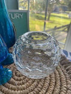 a glass vase sitting on top of a wicker table