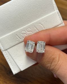 Introducing a perfect matching pair of 4-carat emerald cut diamond stud earrings. The fine jewelry gift of a lifetime.  Unisex lab-grown CVD diamond stud earrings. Emerald cut, 4 carats each, 4-prong basket set with pushback closure, and IGI certified.  Hypoallergenic, and waterproof. Ships overnight from Miami Florida.   Setting Details:  - Metal: 14K Gold  - Setting: 4-Prong - Style: Basket Diamond Details:  - Carat: 4.01 - Cut: Emerald - Clarity: VVS2 - Color: H - Measurements: 10.64 x 7.56 x Luxury Diamond Earrings With Square Cut, Luxury White Gold Emerald Cut Diamond Earrings, Luxury Baguette Cut Earrings For Engagement, Luxury Rectangular Earrings For Anniversary, Luxury Silver Earrings With Diamond Markers, Luxury Classic Lab Grown Diamond Earrings, Luxury Baguette-cut Lab Grown Diamond Earrings, Estate Diamond Earrings, Luxury Emerald-cut Baguette Diamond Earrings