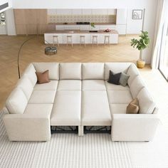 a large white couch sitting in a living room on top of a hard wood floor