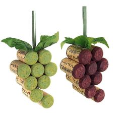 two wine corks with plants growing out of them, one is green and the other is red