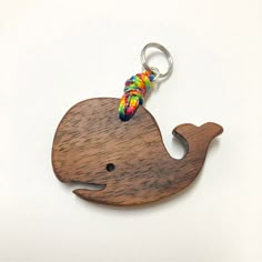 a wooden keychain with a colorful bead on it's head and tail