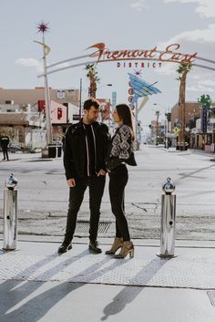 a man and woman standing next to each other in front of a sign that says fremont city