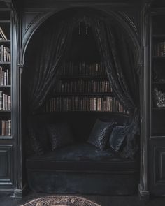 a bed in a room with lots of bookshelves