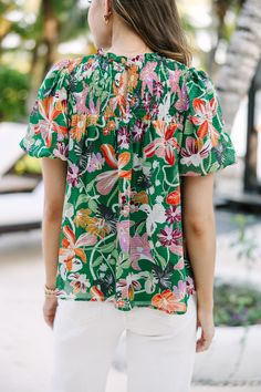 We hope you have all the plans for this blouse! It's sure to take you from the office to the beach side restaurant! That tropical floral print is so fun and colorful! Round neckline Smocked yoke Button keyhole back Short bubble sleeves Tropical floral print No stretch Savannah is wearing the small. Multicolor Short Sleeve Smocked Top For Summer, Tropical Tops With Vibrant Print For Vacation, Green Hawaiian Top For Spring, Spring Hawaiian Green Top, Vacation Smocked Top With Short Sleeves, Green Tropical Print Blouse For Vacation, Tropical Green Printed Blouse, Multicolor Tops With Smocked Back For Brunch, Tropical Print Vacation Blouse