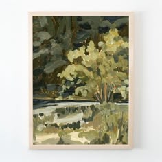 a painting hanging on the wall next to a white wall with a tree in it