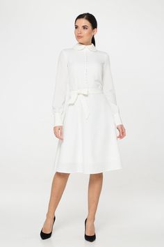 "A collared midi dress featuring a button front closure (imitation), fabric belt, and a fit and flare silhouette. - fit and flare silhouette - high rounded collar - knee length (midi) - long sleeves with cuffs - fabric belt - covered button front decor - concealed zipper closure - lined bodice and skirt - color: white Fiber: 60% viscose, 35% polyester, 5 % elastane, Lining - 95 % viscose, 5% elastane. For size S:dress length- 40,0 \" (102 cm), sleeve length 24,21\" (61,5 cm) Our model wears size White Midi Dress Long Sleeve, Flare Dresses For Women, Long Sleeve White Midi Dress, Long Sleeve White Dress, White Dress Spring, Wedding Dress Casual, Bridesmaids Jumpsuits, High Collar Dress, Fit And Flare Dresses