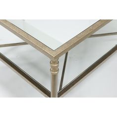 a glass and metal table with gold trim