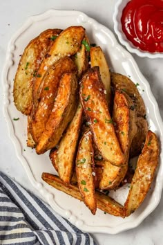 baked potato wedges on a plate with ketchup