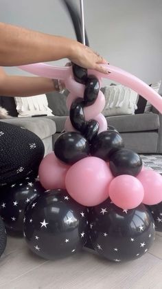 black and pink balloons are stacked on top of each other