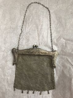 Late 1800's German silver mesh purse. Mesh is in great condition. Missing one bead on the bottom. Mesh part measures 6" wide, 5" tall. 7" by 6" with the decorative clasp included. Chain is approx 17" Handmade Victorian Style Silver Bags, Silver Antique Rectangular Evening Bag, Antique Silver Rectangular Evening Bag, Vintage Silver Rectangular Coin Purse, Antique Silver Bag For Party, Engraved Silver Evening Bag, Silver Rectangular Coin Purse For Evening, Victorian Silver Bag For Gift, Silver Antique Evening Bag