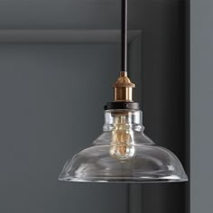 a clear glass light fixture hanging from a ceiling