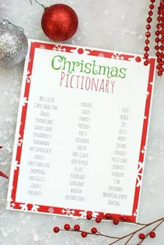 a printable christmas dictionary on a table next to ornaments and bauble balls