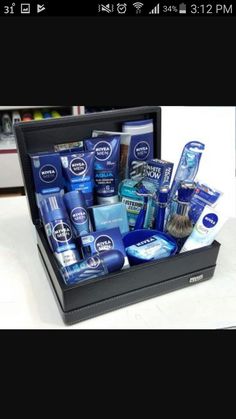 an open black box filled with men's grooming products on top of a counter