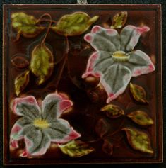 an image of some flowers that are in the glass block with colored inks on it