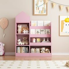 a child's room with pink bookshelves and stuffed animals on the floor