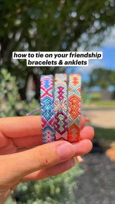 two bracelets in the palm of someone's hand with text overlaying how to tie on your friend's bracelets & anklets