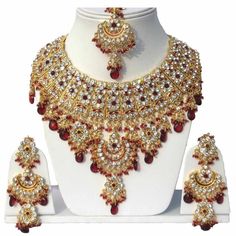 Product Description: * Gold Plated Jodha's Kundan Zerconic Bollywood Necklace Set Jewelry * The base metal color is Gold tone studded with kundan along with beads work on it. * This Jewelry set would add more charms to your beautiful jewelry collection and would surely bring lots of compliments . * Note:- This is an artificial Jewelry Set. * Care Instructions: Keep it dust-free & dirt free in a plastic pouch. Remember to apply your hairspray, perfume, and cosmetics before putting your jewellery Maang Tikka Set, Bride Things, Tikka Jewelry, Indian Bridal Jewelry Sets, Gold Necklace Indian, Jewelry Set Design, Gold Necklace Indian Bridal Jewelry, Indian Bridal Jewelry, Bollywood Wedding