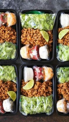 six plastic containers filled with taco salads and lettuce wrapped in paper