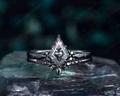 a diamond ring sitting on top of a rock