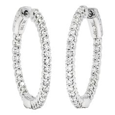 Introducing our exquisite Natural Diamond Hoops in 18KT White Gold—a true embodiment of elegance and luxury. These Single Row Diamond Hoop Earrings are meticulously crafted to elevate your style and make a lasting impression. Designed with utmost attention to detail, these elegant diamond hoops feature a single row of stunning natural diamonds. Each diamond is expertly set in a sleek and sophisticated 18KT white gold hoop, creating a captivating and timeless design. The brilliance of the diamonds combined with the lustrous white gold setting exudes a luxurious aura that will turn heads wherever you go. Indulge yourself or surprise a loved one with these magnificent Natural Diamond Hoops. They make a truly unforgettable gift for any occasion, symbolizing love, celebration, and enduring eleg Timeless Oval Hoop Earrings For Anniversary, Oval Brilliant Cut Hoop Earrings For Formal Events, Timeless White Gold Hoop Earrings For Anniversary, Oval Hoop Earrings With Brilliant Cut For Formal Occasions, Classic Small Hoop Diamond Earrings With Halo Design, Timeless Diamond Cut Hoop Earrings For Anniversary, Classic White Gold Hoop Earrings With Halo Design, Timeless White Hoop Earrings For Anniversary, Timeless Hoop Diamond Earrings For Anniversary