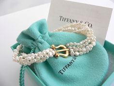 Overview:Every woman needs a strand of pearls ... but here's a piece that's more special than just any strand of pearls ... because it's made by Tiffany! :) Offered for sale is a wonderful Tiffany & Co. Picasso 18K Gold Buckle Multi Strand Pearl strand bracelet. Whether you are just starting your collection or are thinking of adding another piece, this one is perfect for you. This pearl bracelet is a gorgeous classic that will never go out of style. The piece is composed of 4 pearl strands with Strand Of Pearls, Pearl Strand, Pearl Strands, Strand Bracelet, Gift Pouch, Tiffany Heart, Bracelet Gold, Heart Charm Bracelet, Multi Strand