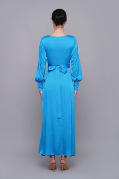 "A long sky blue dress featuring a flowing pleated skirt, long sleeves with cuffs, and a v-neckline. - Maxi length - A line silhouette - Long puffy sleeves with cuffs - V neckline - Belted - Concealed side zipper closure - Lined Color: sky blue Fiber: viscose 35%, polyester 60%, elastane 5% Lining: 95% viscose, 5 % elastane For Size S (6 US): dress length - 53\" (135 cm) Our model wears size S (06) and is 176cm/5'8\" tall. You may feel free choosing the size. Just send us your measurements (bust Spring Long Sleeve Bridesmaid Midi Dress, Spring Bridesmaid Midi Dress With Long Sleeves, Long Sleeve V-neck Evening Dress, Elegant Long Sleeve V-neck Dress For Dinner, Chic Long Sleeve Bridesmaid Midi Dress, Long Sleeve Satin Dress For Wedding Guest, Modest Long Sleeve Evening Maxi Dress, Chic Long Sleeve Midi Bridesmaid Dress, Modest Long Sleeve Maxi Dress For Formal Events