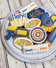 decorated cookies in the shape of nerf on a plate