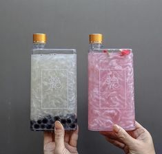 two people holding plastic containers with food inside