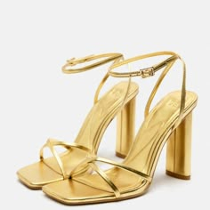 Strappy Metallic Heeled Sandals Metallic High Heel Sandals. Crossed Front Straps. Squared Toe. Heel Height: 3.9 Inches (10 Cm) 3337/110 Gold Sandals With Heel And Ankle Strap, Gold Block Heel Heels For Spring, Glamorous Gold Heels For Summer, Gold Ankle Strap Sandals For Night Out, Gold Ankle Strap Heels For Summer, Gold Open Heel Sandals For Party, Gold Open Heel Party Sandals, Glamorous Gold Ankle Strap Sandals, Gold Sandals With Padded Heel For Night Out