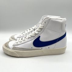 Elevate your casual style with these Nike Women's Blazer Mid '77 Game Royal Blue Sail White sneakers. The mid-top shoe shaft style with lace-up closure features a solid pattern with a round toe shape that provides comfort and durability. The white color with a royal blue accent and Nike logo add a touch of elegance to these sneakers that make them perfect for any casual occasion. Crafted with leather upper material and foam insole material, these sneakers ensure long-lasting support and cushioning. The rubber outsole material provides excellent traction on any surface. These Nike Blazer Women's Sneakers are new with the box and come in size 7.5. Defect: right toe stains and left midsole yellowing Blazer Mid 77 Outfit, Mid Top Shoes, Nike Blazers, Blue Accent, Everyday Shoes, Blazer Mid, Mid Top, Nike Blazer, Blue Accents