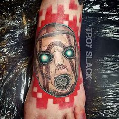 a person with a tattoo on their foot wearing a gas mask and glowing green eyes