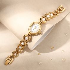 Are you ready to attract everyone's envious gaze? This vintage gold pearl women's watch is like a piece of jewelry in a classic movie, instantly making you the focus of the audience. The golden dial is like the autumn sun, and the pearl-like decoration shines with charming light. Every gaze is like a dialogue with time. The most special thing is that this watch is customized with a name and is purely handmade! 👀 Warm Tips: The watch can be resized by linking the disassembly tool (the disassembl Charm Bracelet Watch, Pearl Watch, Watch Womens, Name Vintage, Small Watch, Watch Gift, Style Watch, Watches Unique, Valentine's Gift