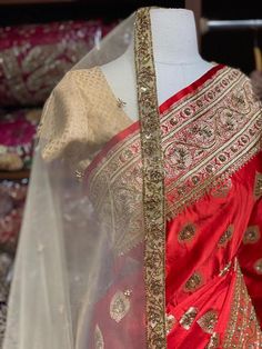 Bright Red Banarasi Silk Saree with an ensemble of fine work beads, pearls and sequins highlight intensifies the look of the Saree. Cut dana and zari work makes it a must way outfit for every bride to be. The saree has an unstitched blouse and a contrasting net dupatta is another great way to add it to your bridal wear. Fabric: Pure Silk Custom designed according to client measurements and color preference. Production and delivery time is 120 days! Red Dupatta For Designer Wear And Transitional Season, Festive Red Traditional Designer Wear, Designer Red Dupatta, Transitional Red Raw Silk Sets, Transitional Season Red Raw Silk Sets, Elegant Red Sharara With Dori Work, Red Art Silk Anarkali Set With Gota Work, Red Raw Silk Anarkali Set With Pallu, Red Kundan Anarkali Set With Gota Work