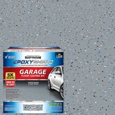 a box of garage paint sitting on top of a gray floor next to a white car