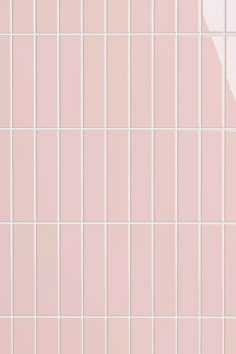 a pink tiled wall with white tiles on it