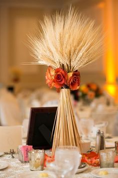 a vase filled with flowers sitting on top of a table next to glasses and candles