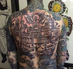 the back of a man with tattoos on his body